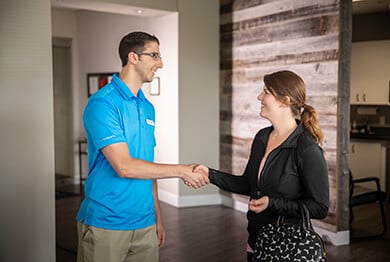 Therapist meeting and shaking hands with patient.
